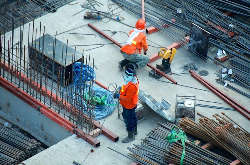 Construction blueprints, safety helmet, and estimation materials